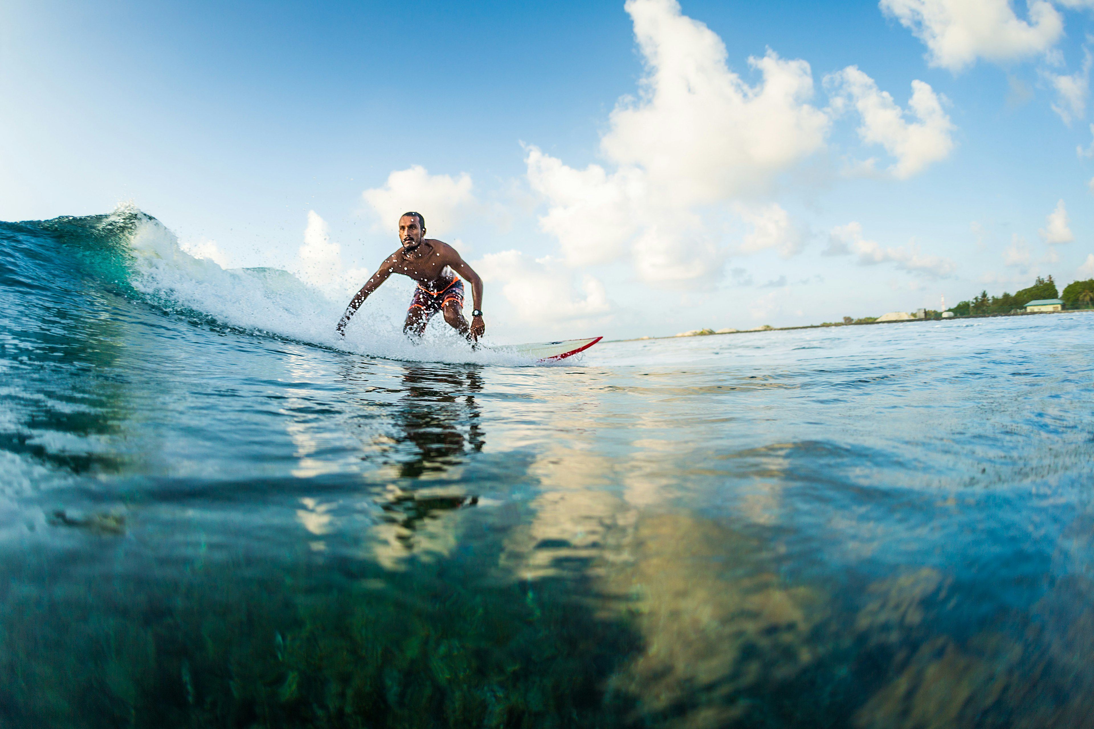 A surfer rides a wave