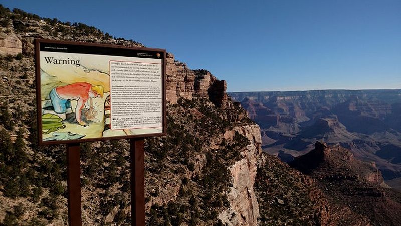 A 'Victor Vomit' sign warning hikers of the dangers of heat illness on the upper Bright Angel Trail