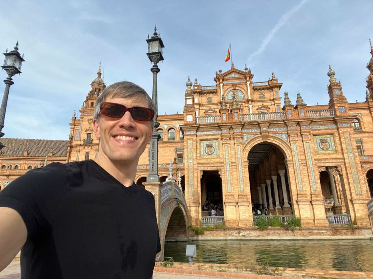 Author Nate taking a photo at Plaza de España in Seville, Spain